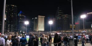 Crowd at a floodlit ballpark in Charlotte at night with the lit Uptown skyline rising behind