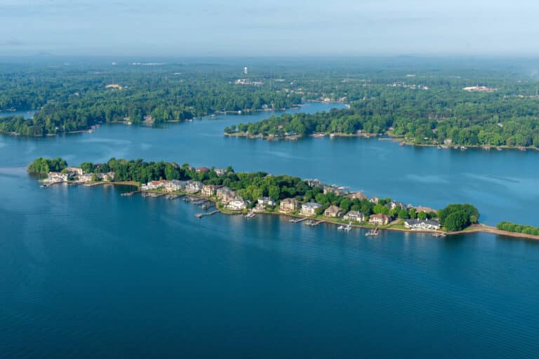 Aerial view of Lake Norman in North Carolina with blue water, wooded shoreline and lakefront homes with private docks